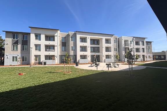 A large building with a lawn in front of it.