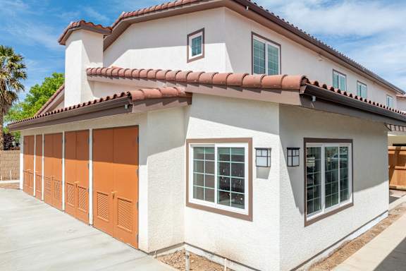 A house with a red tile roof and a white garage door.