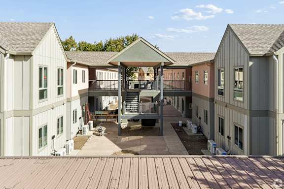 A large building with a patio and a gazebo in the middle.