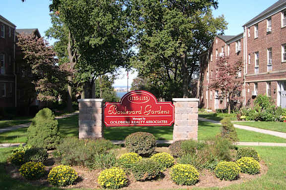 A sign for Bowleord Gardens is in front of a building.