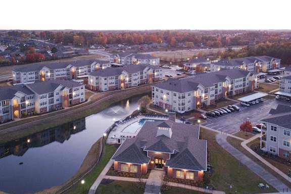 an aerial view of an apartment complex next to a body of water at Cumberland Place Apartment Homes, Texas