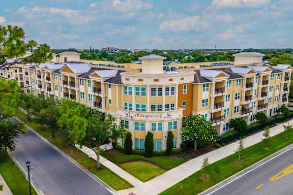 A large apartment complex with the name "village gate" on the front.