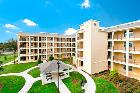 a large apartment complex with a courtyard and picnic area