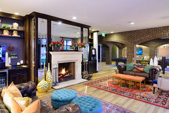 A living room with a fireplace and a TV.