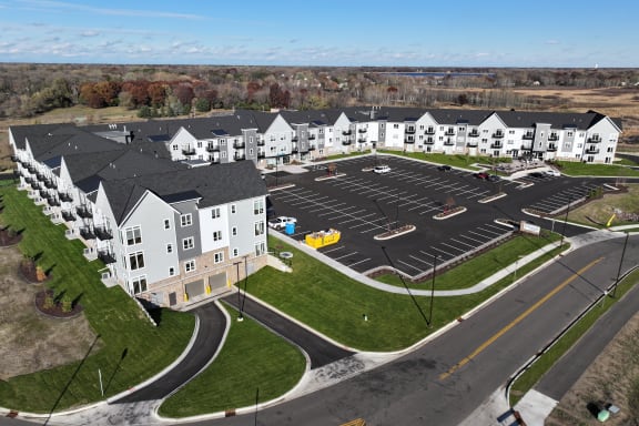an aerial view of an apartment complex with a parking lot