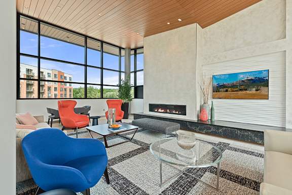 a living room with a fireplace and large windows
