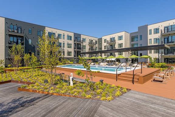 A modern building with a pool in the courtyard.