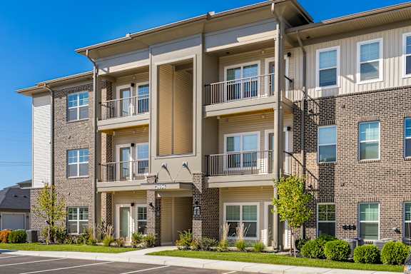 Apartment building with a clear blue sky above.