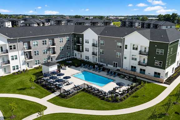 A large apartment complex with a pool in the middle.