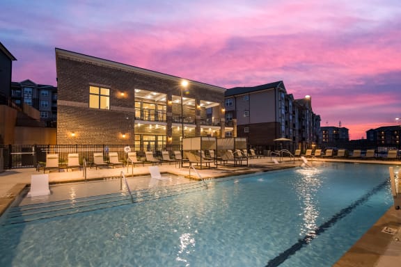 a swimming pool with a pink sunset in the background  at Ardmore at Bryton, Huntersville