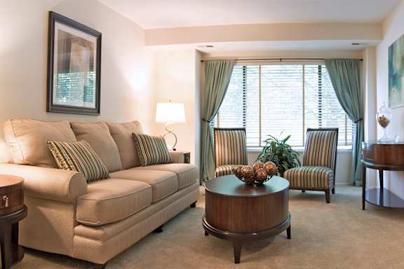 A living room with a couch, chair, and coffee table at Reflection Knoll at 5 Corners, Timonium, MD, 21093