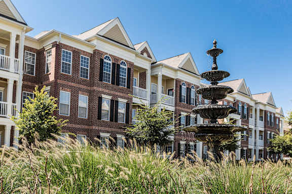 A large building with a fountain in front of it.