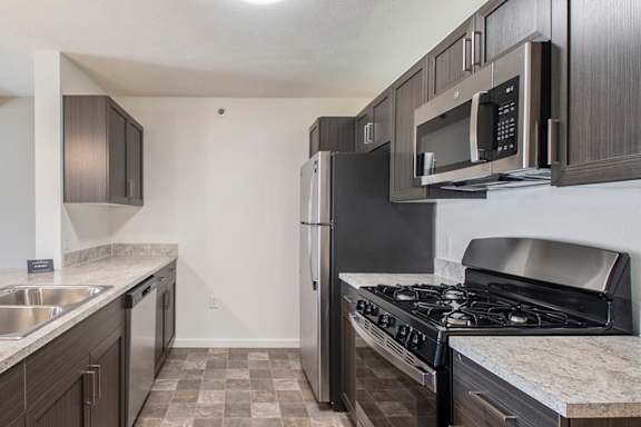 A kitchen with a black fridge and stove at Andover Pointe Apartment Homes, La Vista, 68138