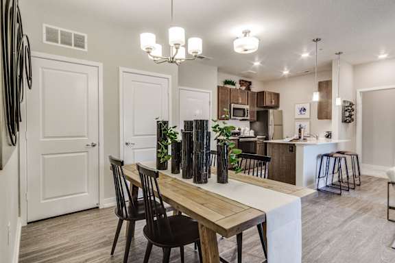 A dining area with a wooden table and chairs.