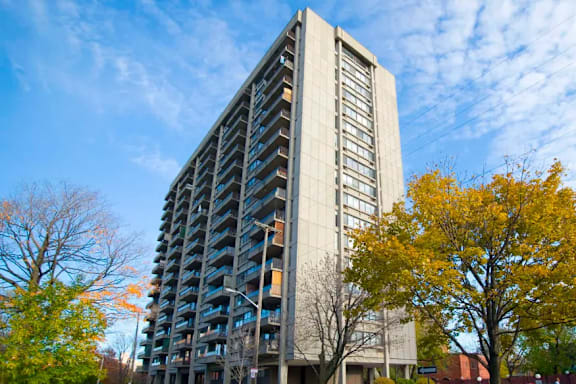 A tall residential building with balconies on each floor.