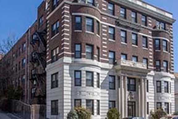 a large brick building with a street in front of it