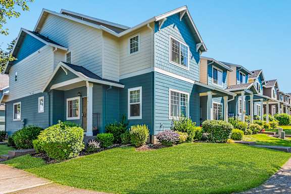 A row of townhomes with blue and white siding at The Landing Apartments and Townhomes, Oregon, 97045