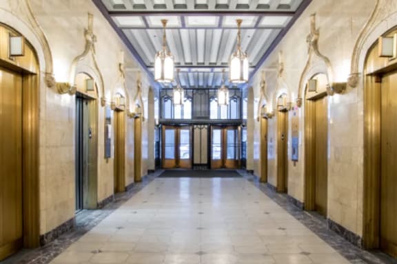 the lobby of a building with vaulted ceilings and wooden doors