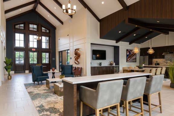 a large lobby with a bar and a living room  at The Clearing at ONE28, Olathe, KS, 66062