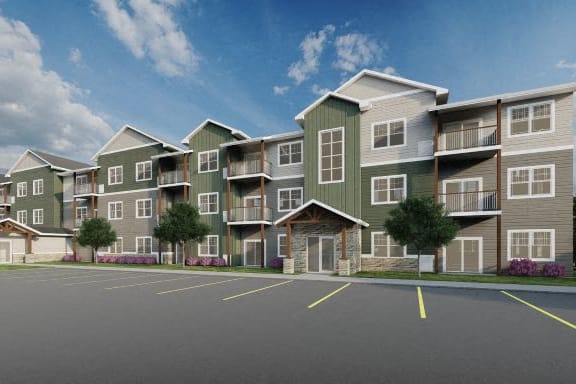 a large parking lot in front of an apartment complex at Pinehurst Apartments, Baxter, 56425