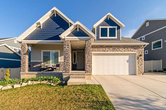 A house with a blue roof and a white garage door.
