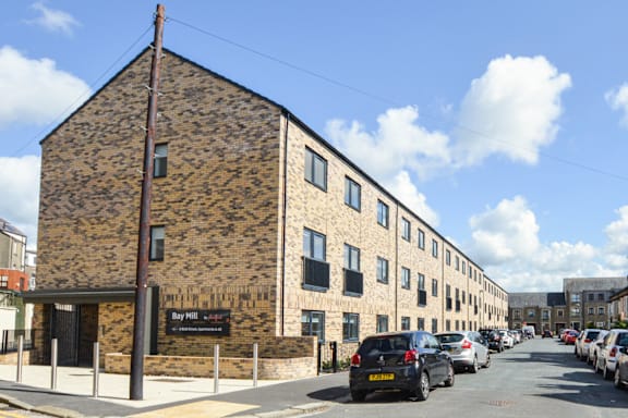 a large brick building with cars parked in front of it