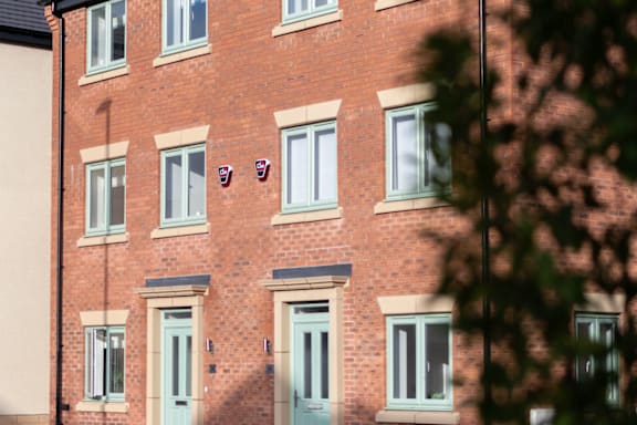a brick house with a blue door and windows