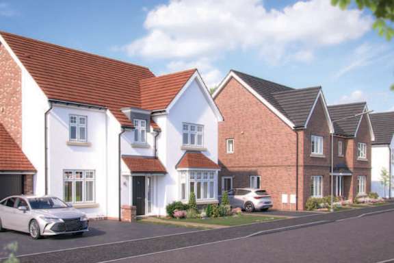a row of new town houses on a street with a car