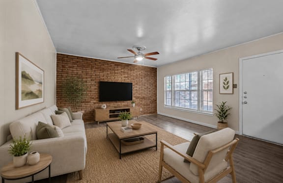 A living room with a couch, chair, and a television.