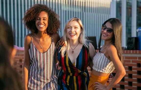 a group of women standing next to each other