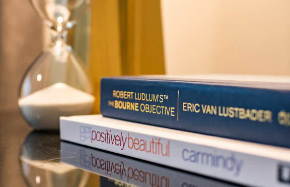 three books stacked on top of each other on a table at 44 Washington, Kansas City, MO