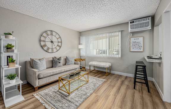 A bedroom with a large bed and a chair at The Marquee Apartments, North Hollywood, California