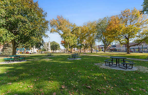 A park with green grass and trees.