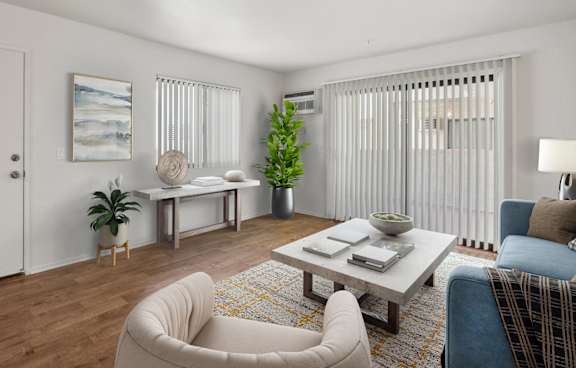 A modern living room with a grey rug and a grey sofa.