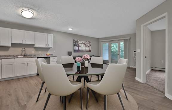 A modern dining room with a table set for two.
