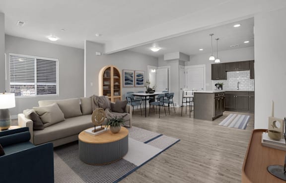 A modern living room with a glass table and chairs, a sofa, and a TV.