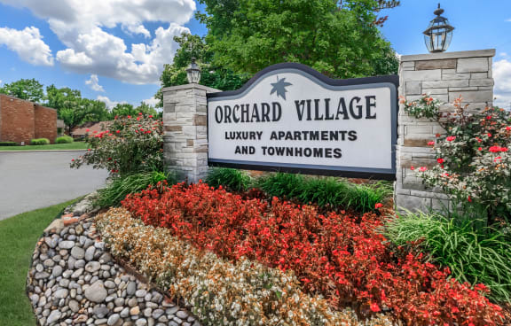 a sign that reads orchard village luxury apartments and townhomes