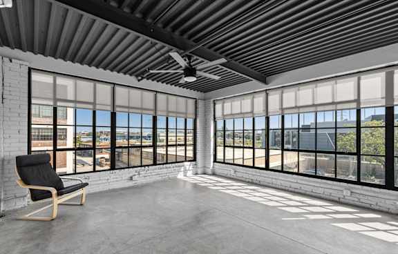 a kitchen and dining area with large windows and a table and chairs