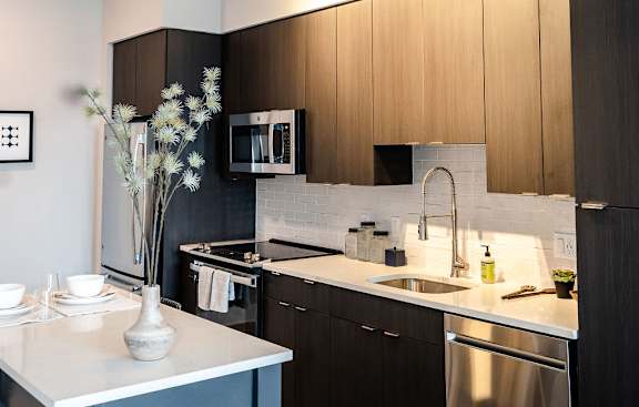 a kitchen with wooden cabinets and stainless steel appliances