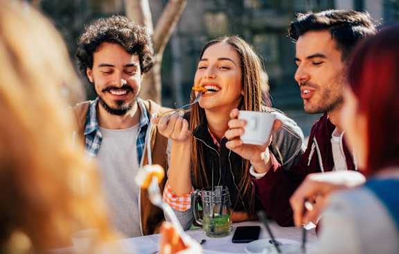 A group of people enjoying a meal together outdoors.