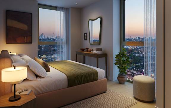 Bedroom with king-size bed, bedside lamp, full-length mirror, and panoramic views.