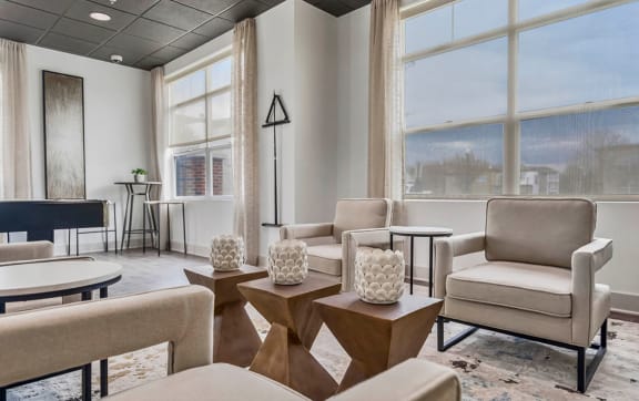 a waiting room with chairs and tables and large windows at CityView, North Kansas City