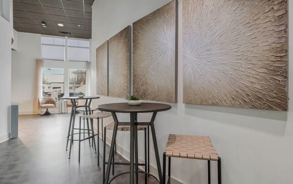 a seating area with stools and a table in a lobby at CityView, North Kansas City, MO