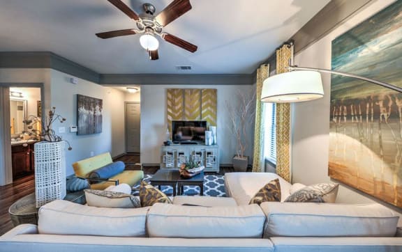 an open living room with a couch and a door to a balcony at The MK, Indiana