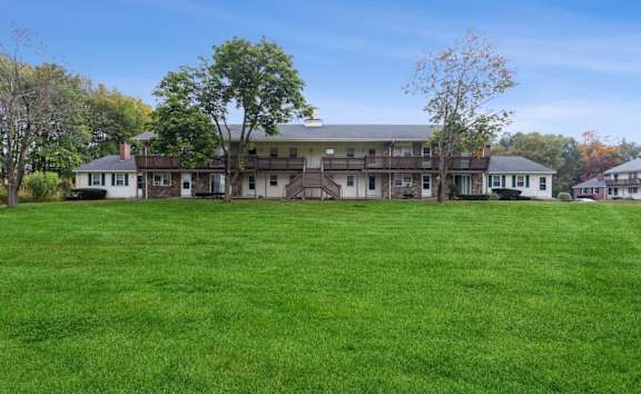 a sign for stonebridge apartments in a park at Stonebridge, Ellington, Connecticut