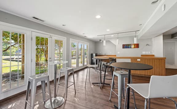 a kitchen and dining room with tables and chairs