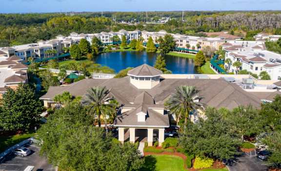 A bird's eye view of a residential area with a lake and houses.