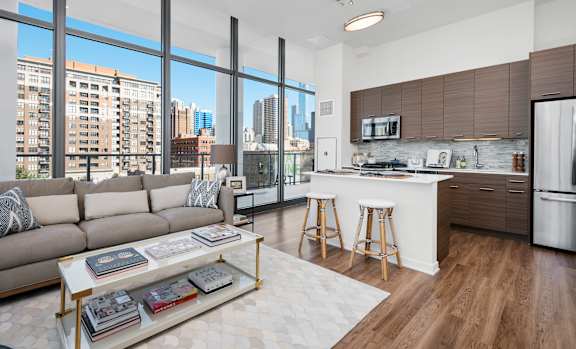 A modern living room with a large window overlooking the city.