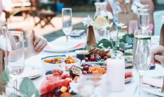a table full of food and people sitting at a table