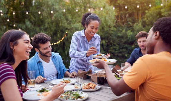 a group of people sitting around a table eating food at Sonoma at Mapleton, California, 92563